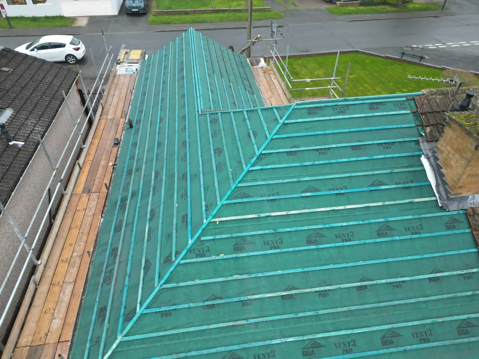 New pitched roof installation with green underlay and wooden battens